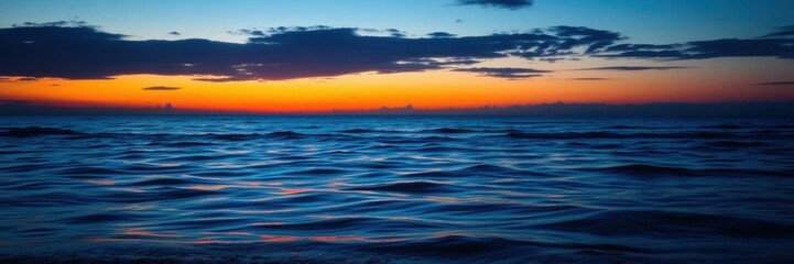 Obraz premium Neon blue and yellow lights reflected on a calm body of water at sunset, sunset glow, evening atmosphere