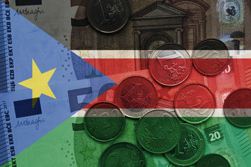 colourful national flag of south sudan on a euro money banknotes and coins background. finance...