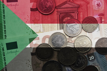 colourful national flag of sudan on a euro money banknotes and coins background. finance concept.