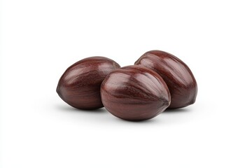 Three polished brown seeds on white background