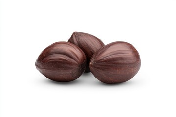 Obraz premium Close-up of three brown hazelnuts on a white background