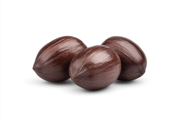 Obraz premium Three whole nutmeg seeds isolated on white background