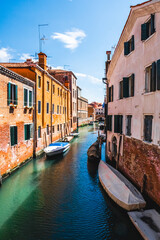 Picturesque Venetian Canal With Vibrant Buildings and Boats in Venice, Italy on a Sunny Day
