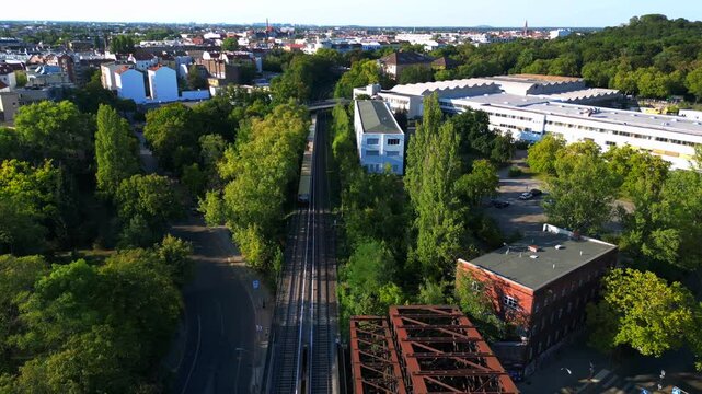 Yellow train crossing bridge Former border Berlin. Best aerial view flight drone