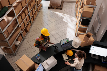 Top view of diverse team working at packages delivery in storehouse, preparing customers orders....