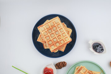 Fresh, homemade waffles on blue plate. Sweet morning breakfast. Healthy food.