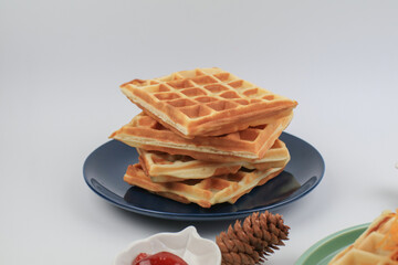 Fresh, homemade waffles on blue plate. Sweet morning breakfast. Healthy food.