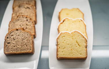 slices of banana bread and pound cake served on white plates, showcasing the texture of the baked goods