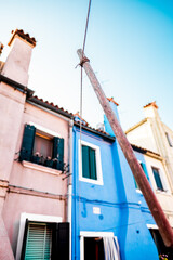 Colorful Venetian Houses Under Clear Blue Sky With Clothesline Pole in Burano Italy