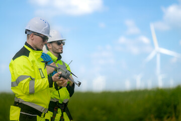 A group of engineers dressed in high-visibility uniforms and helmets conducts an inspection at a...