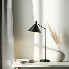 A stylish desk lamp illuminates a serene workspace with a vase of dried plants.