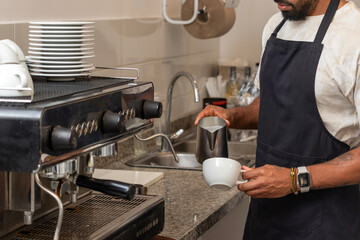 Barista preparing a cappuccino in a coffee shop