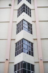 Multi-storey building with glass windows on each floor with triangular corners