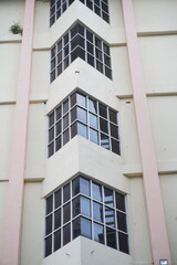 Multi-storey building with glass windows on each floor with triangular corners