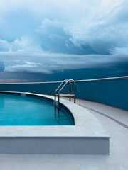 Quiet before the storm at an empty, rooftop swimming pool