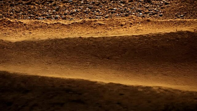 Textured layers of brown earth showcasing natural patterns at sunset creating a serene landscape in the countryside