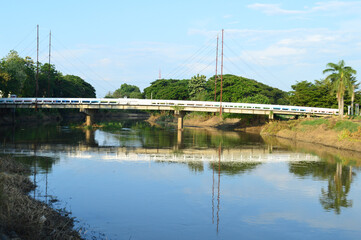 Bridge over the Mae Kuang River in a residential area of Lamphun City, Northern Thailand
