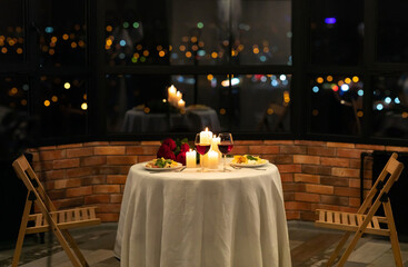 Romantic Date Dinner Concept. Served Table With Food And Burning Candles In Restaurant Interior At Night. No People