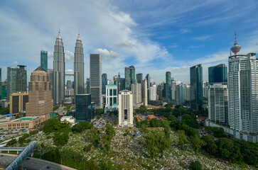 A  view of the KLCC Park in Kuala Lumpur, Malaysia with Saloma Link which connects Kampung Baru and Jalan Ampang. The urban park in Kuala Lumpur City Center is a popular tourist attraction of Asia. 