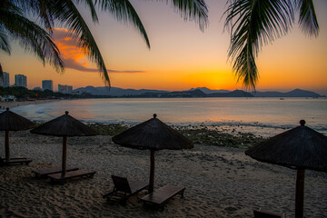 Beach daybeds and the palm trees at Dadonghai beach, Sanya, China