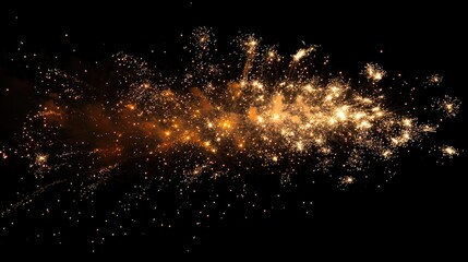 A bright burst of golden sparks and embers explode against a black background.