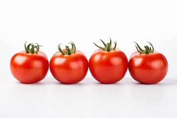 fresh red tomatoes arranged in a row on a white background