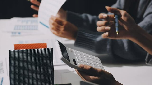 Finance and real estate investment concept, Businessman present business finance investment plan with his partner, Investor colleagues discussing new investment plan by financial graph analytic data
