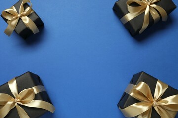 Beautiful gift boxes tied with bows on color background 