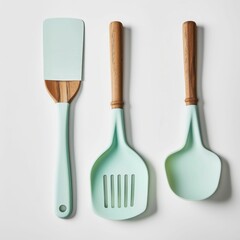 A colorful set of kitchen utensils featuring a spatula and two scoopers, all with wooden handles and a mint-green silicone finish.
