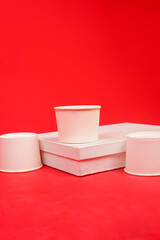 Disposable kraft paper bowls, isolated on red background. High resolution photo.