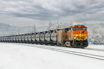 winter scene of a freight train hauling cargo close to Whitefish, Montana