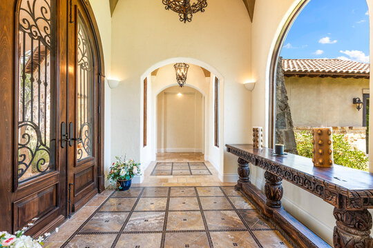 Elegant entrance with decorative arches and natural light illuminating space