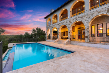 Elegant luxury villa with pool at sunset in serene countryside setting