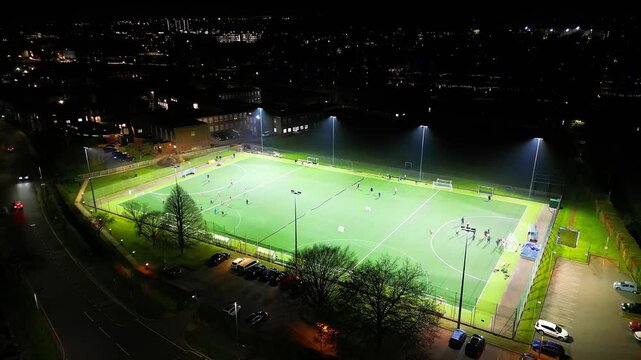 High Angle Night Footage Live Football Game in the Illuminated Football Ground at Bedford City of England UK. Captured with Drone's Camera During Early Night of November 26th, 2024 with Drone's Camera