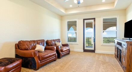 Comfortable living area with leather sofas and a view of the outdoors