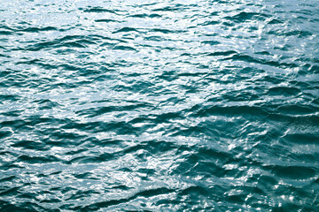 Background of sea water surface. Abstract blue sea water. Background texture. Water in swimming pool, ocean or sea.