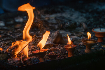 Close up of oil lamp and flame used for religious prayer