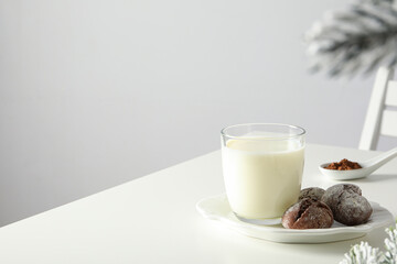 Delicious Grinkle cookies in a plate, with milk, on a light background.