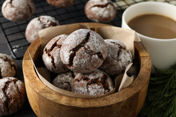 Delicious crinkle cookies in a plate, on a dark background.