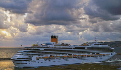 Modern Italian cruiseship cruise ship liner Fascinosa during sunset sail away departure from port...