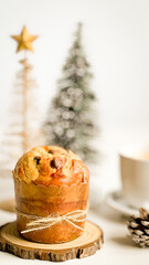 Mini Christmas panettone on the festive table with Christmas decoration.