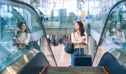 Portrait of standing tourist woman passenger at international airport terminal for holidays travel