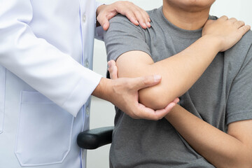 Fototapeta premium Physical therapy, Asian therapist doctor treat perform pain young man in hospital.