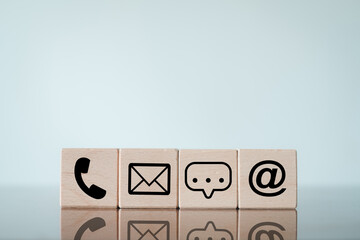 Wooden cube with contact us icon Minimalistic design idea for  customer service, communication channels, and corporate support.