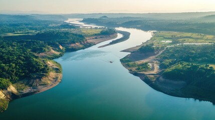 Aerial view of a meandering river flowing through lush green landscape.