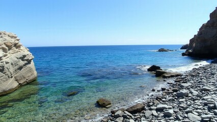 Experience Serene Coastal Beauty: Crystal Clear Waters, Rocky Shores, and Tranquil Blue Skies - Perfect for Wall Art or Travel Inspiration