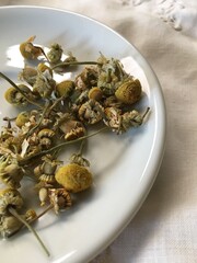 Dried chamomile flowers on a dish clsoe-up