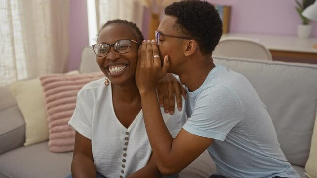 Mother and son bonding in a cozy living room with a loving whisper, capturing a moment of joy and connection in their home