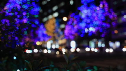 Sparkling Christmas illuminations bokeh image: night view of the city at the end of the year