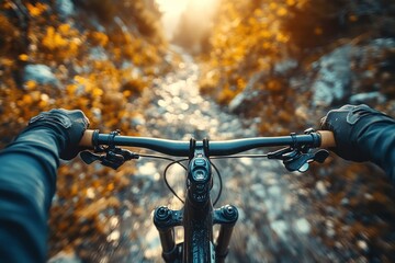 First person view of a mountain biker riding on a dirt path in the mountains at sunset.